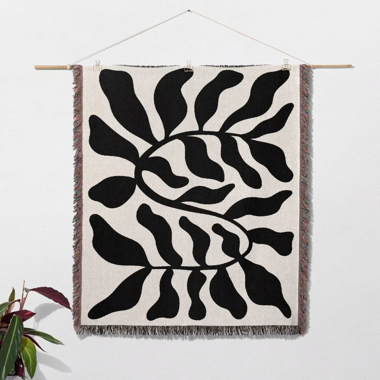 Black leaf Matisse throw blanket as woven wall art with black abstract pattern on a white background