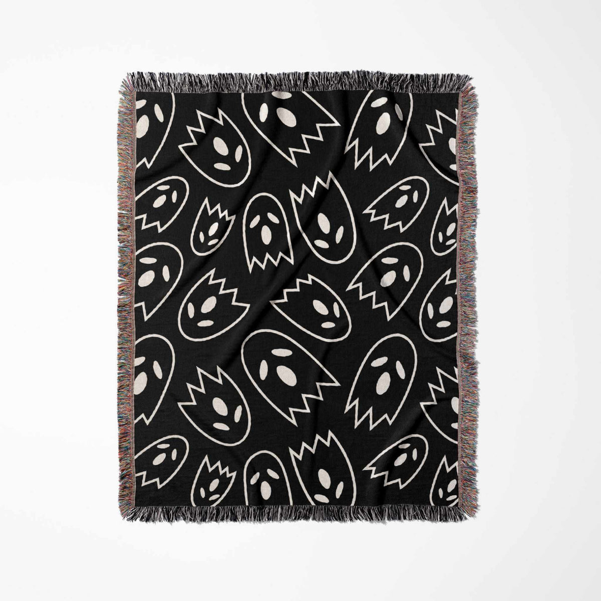Black blanket with white ghost pattern on a white background
