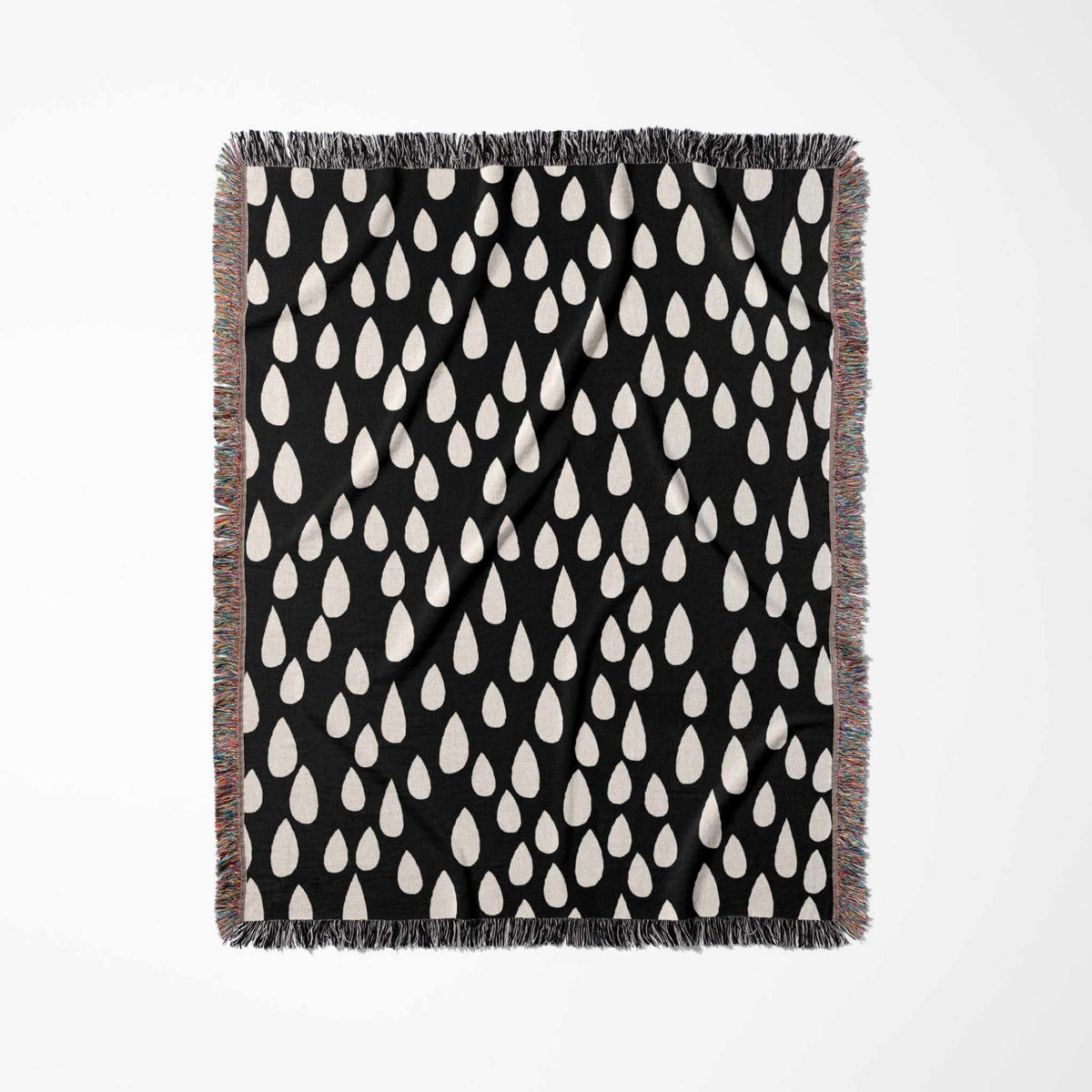 Black blanket with white teardrop pattern on a white background