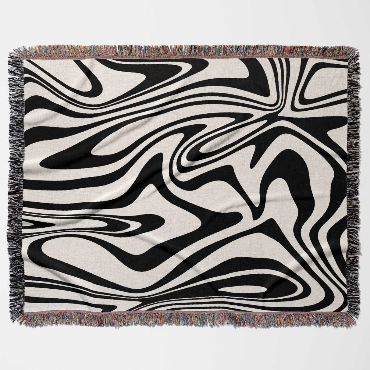 Abstract patterned black and white marble woven throw blanket with black and white design on a beige background