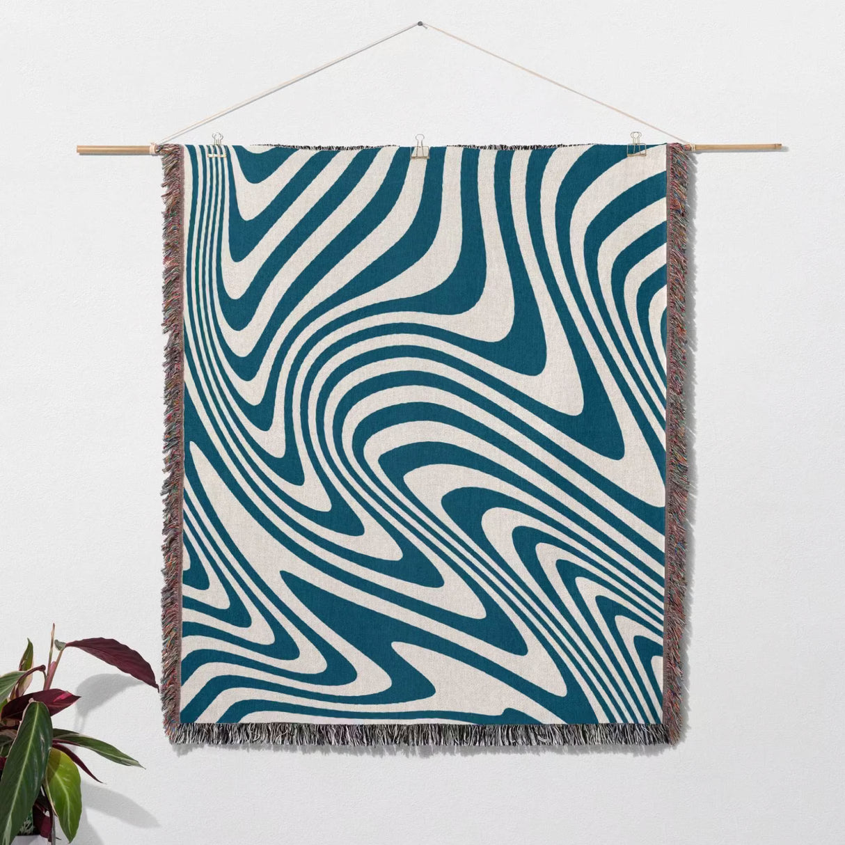 Blue cotton modern decorative woven throw blanket with blue and white pattern hanging on a wall