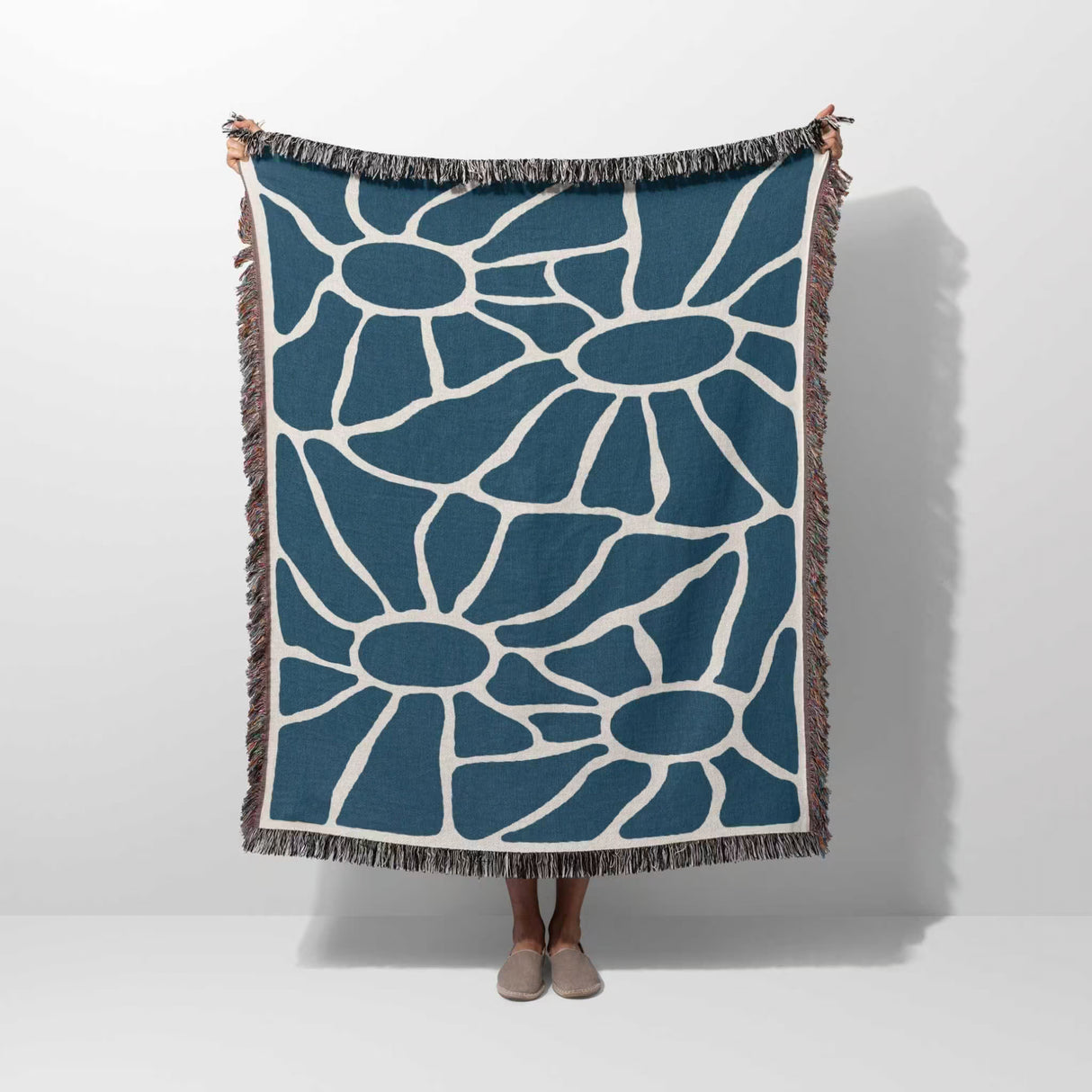 Blue Matisse tapestry throw blanket for couch and bed hold by a person on a white background
