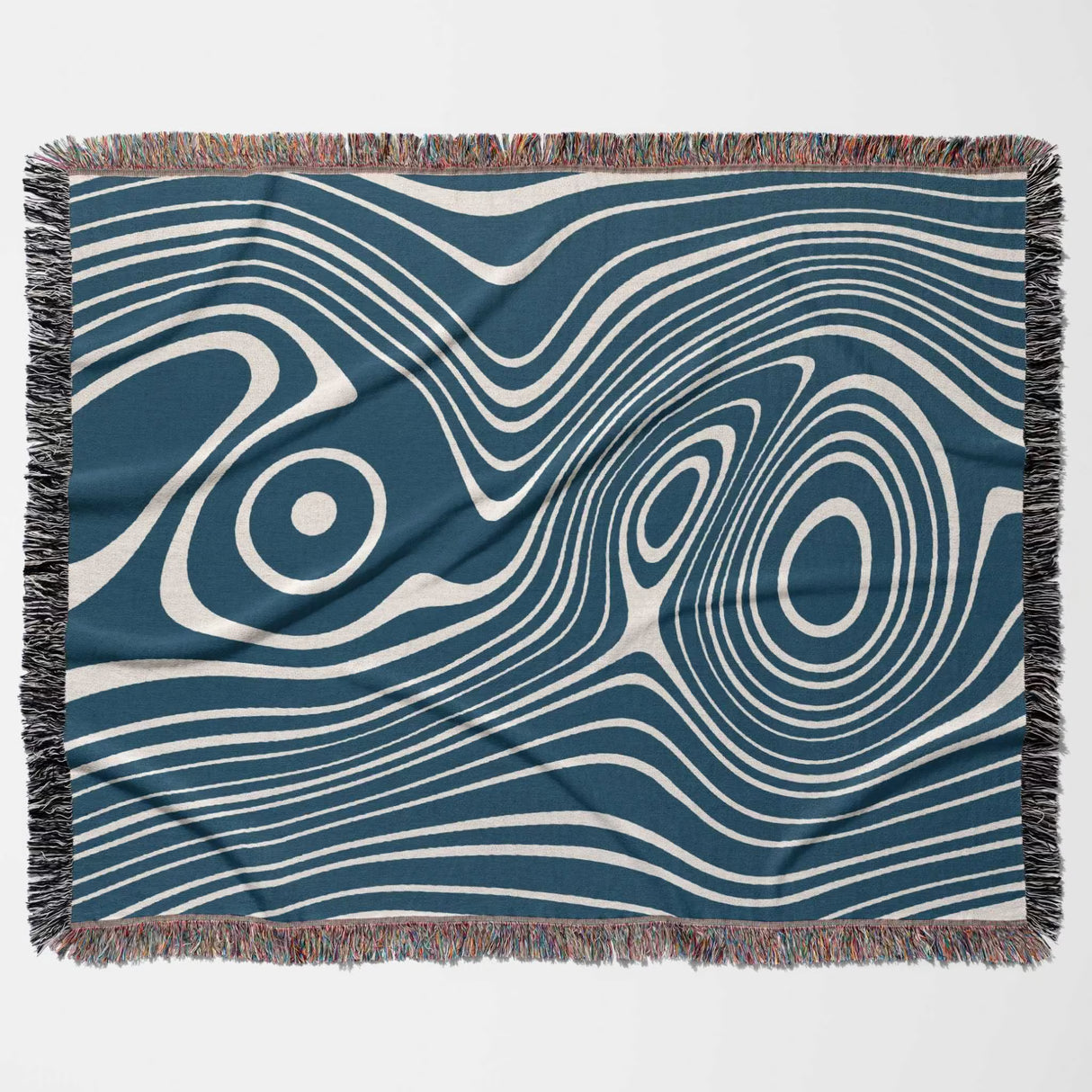 Blue trendy abstract woven throw blanket with wavy line pattern on a blue background