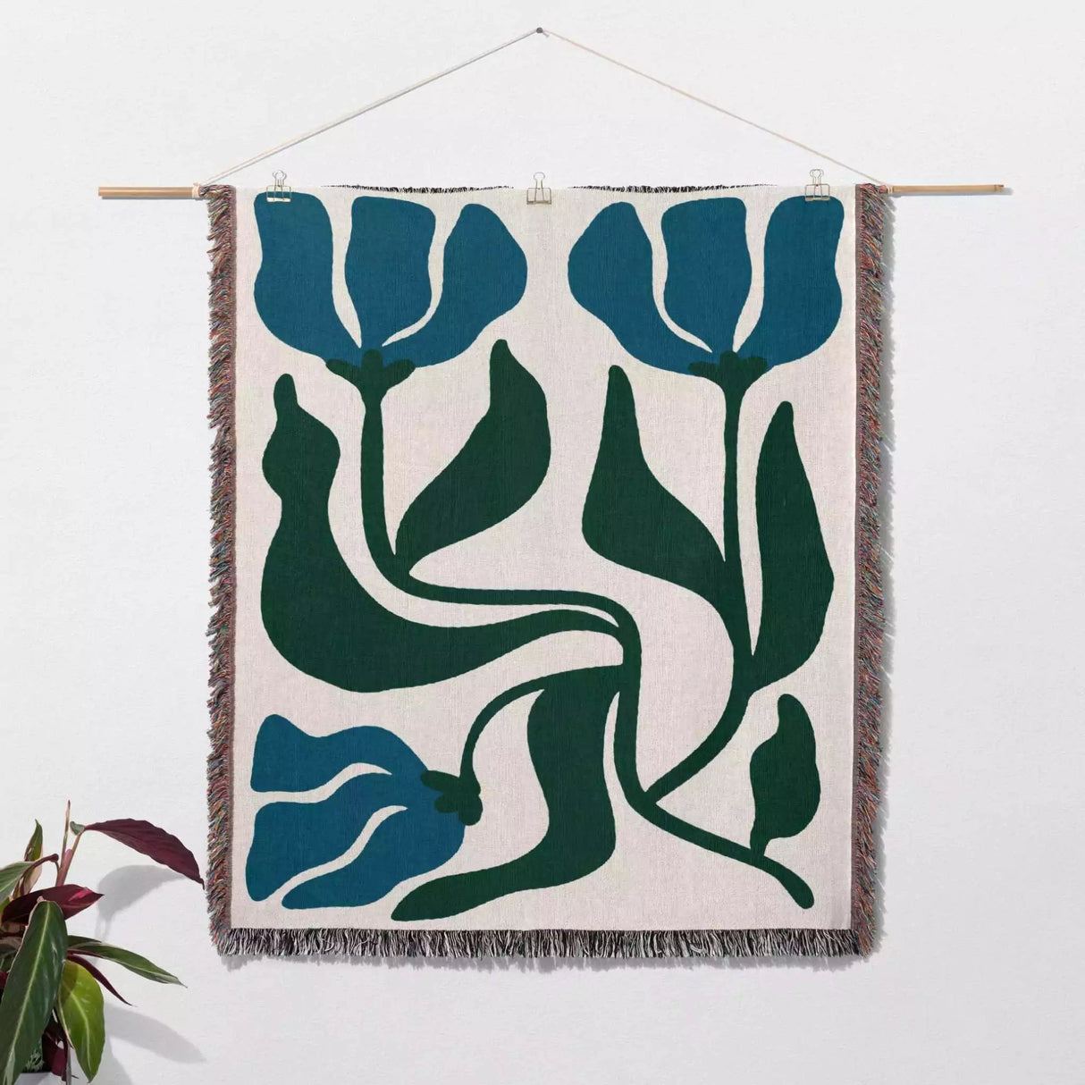 Woven wall art blue and green Matisse flower woven throw blanket with blue and green floral design on a white background