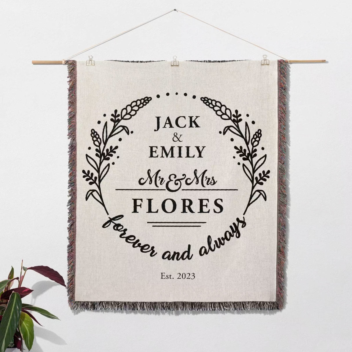 Cotton wedding anniversary gift for him woven throw blanket with 'Jack & Emily Flores' text wall hanging on a white background