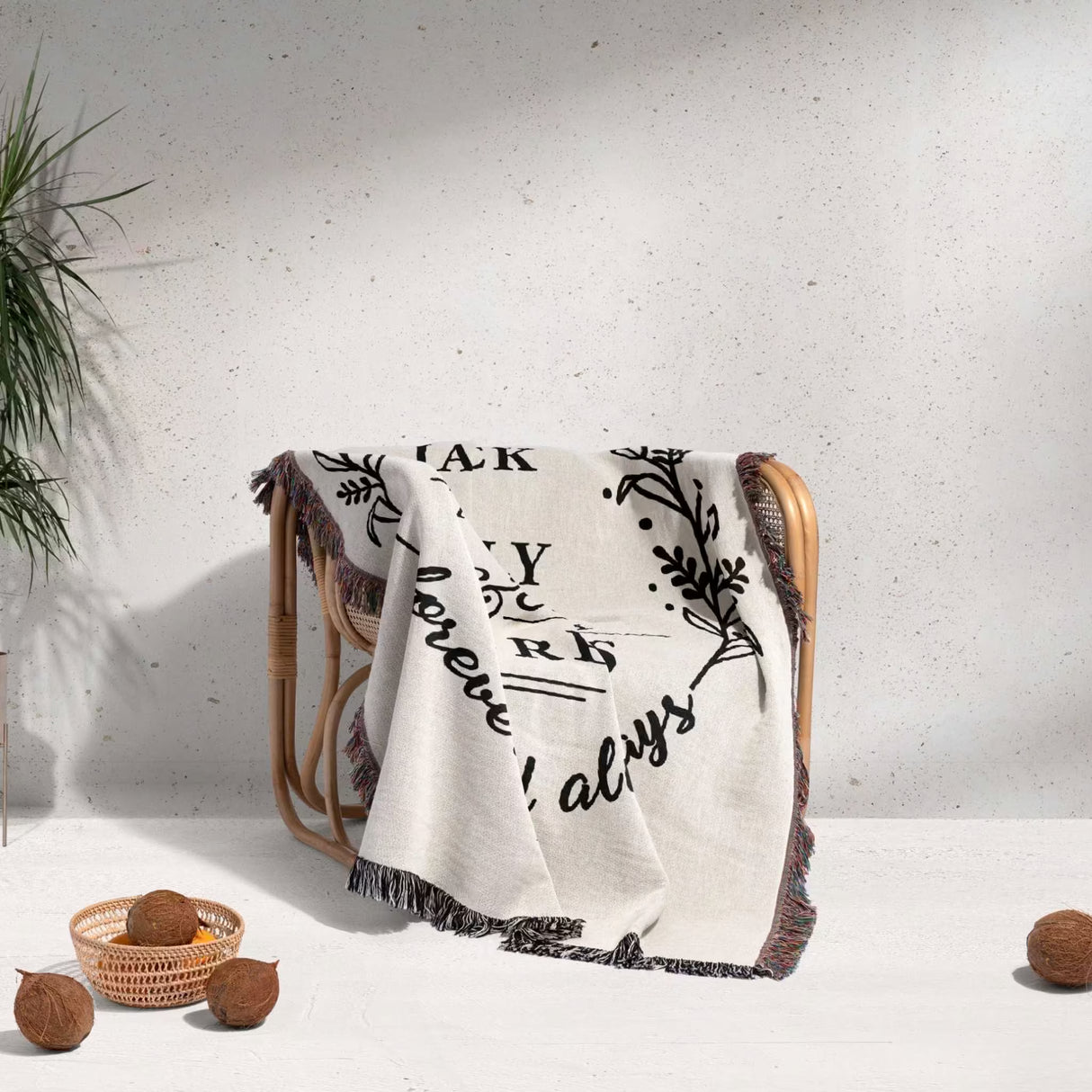 Cotton wedding anniversary gift for him woven throw blanket with text and patterns draped over a chair against a light background