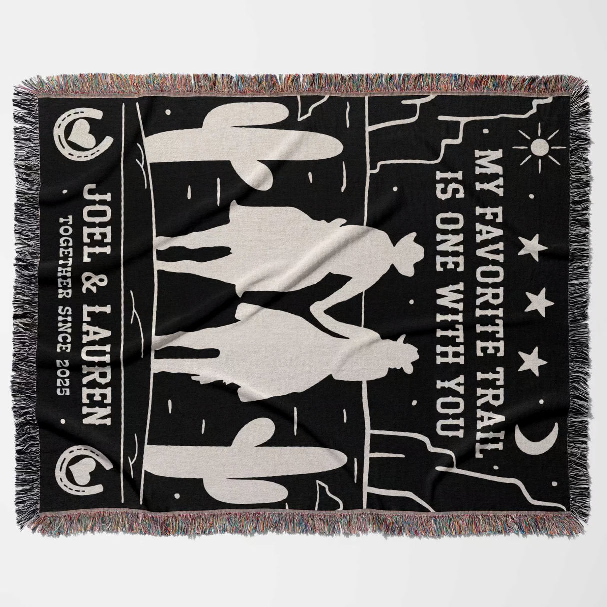 Cowboy and cowgirl on two horses 2nd anniversary gift woven throw blanket flat lay with horse design and text on a black background