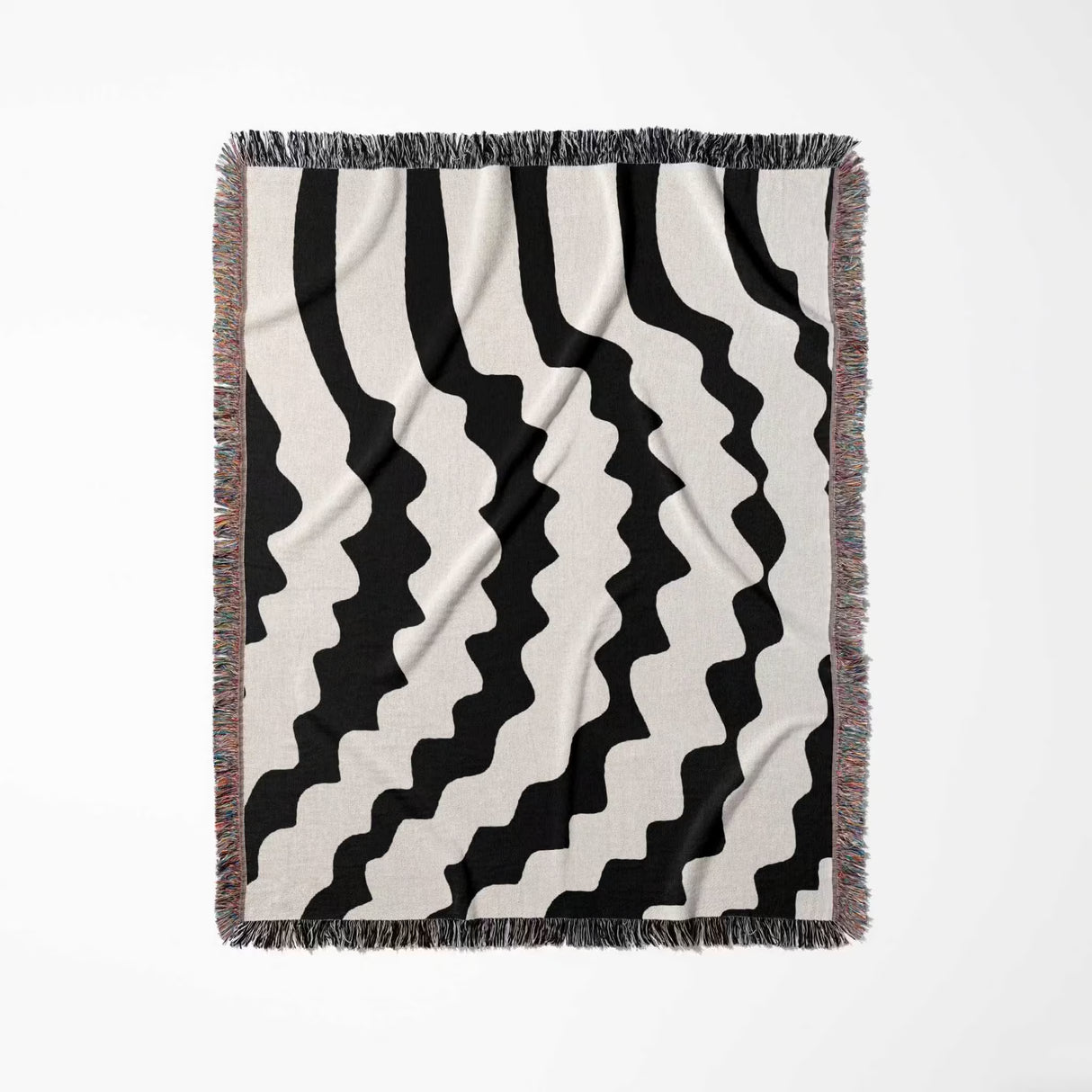 Black and white decorative abstract wavy woven blanket throw full view on a light gray background