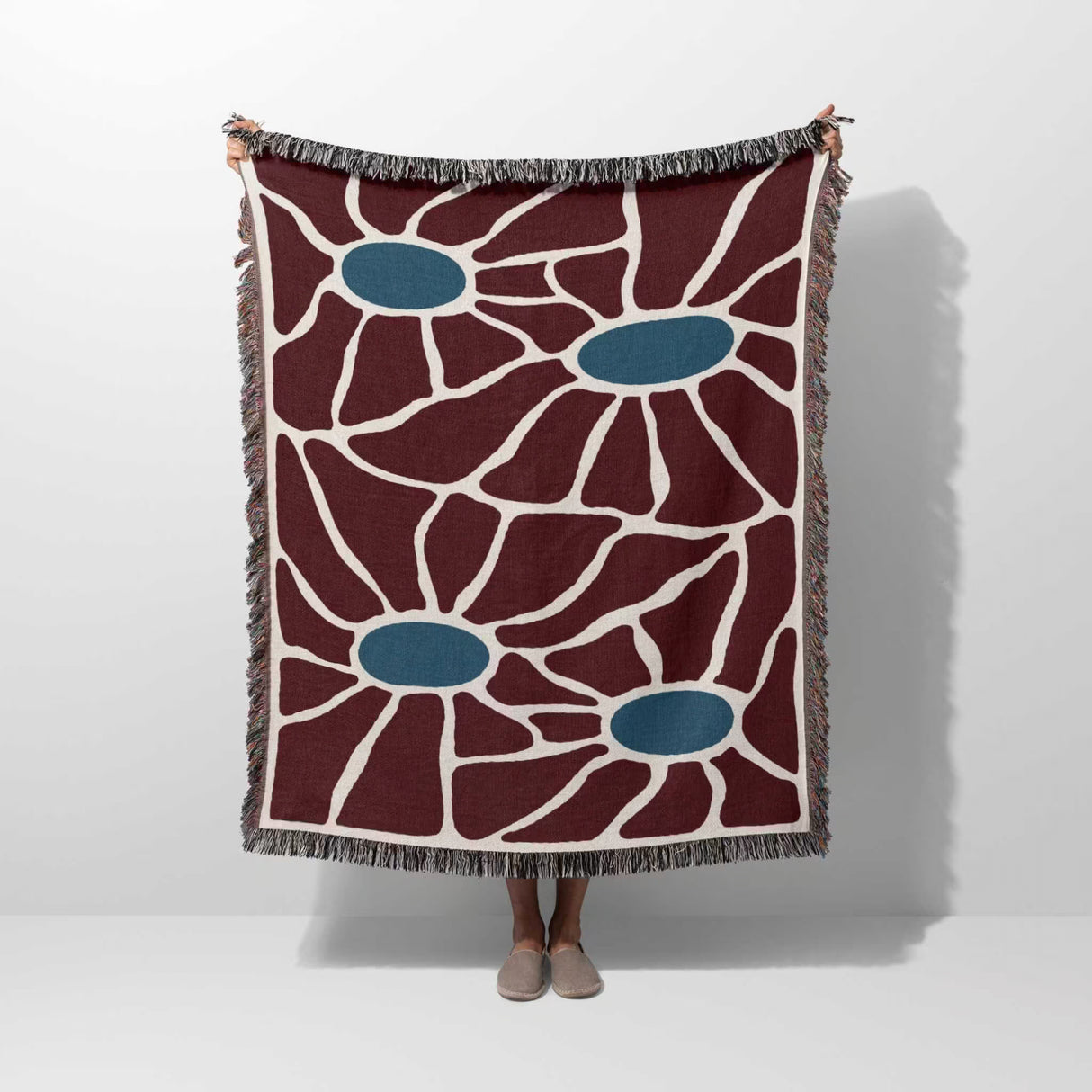 Floral eclectic Matisse inspired tapestry throw blanket for couch hold by a person on a white background