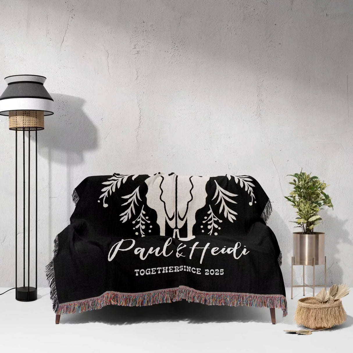 Floral cow skull 2nd anniversary gift woven throw blanket with custom text and designs on a couch in a room with a lamp and plant.
