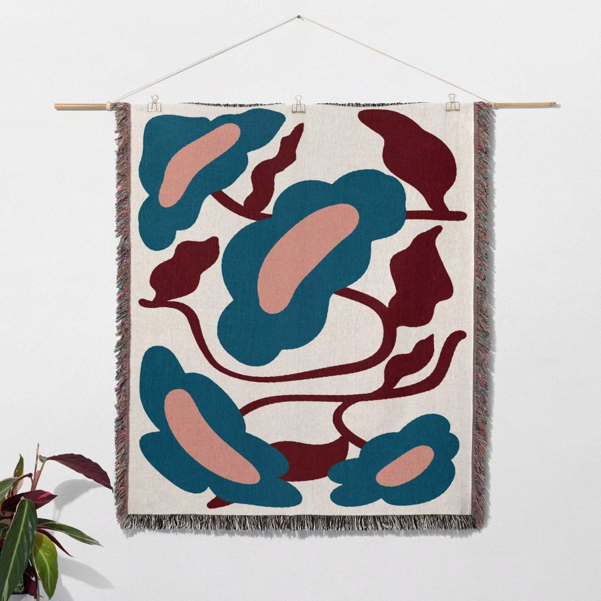 Floral Matisse inspired tapestry throw blanket for couch as a decorative wall hanging with abstract floral design in blue, pink, and red on a white background.