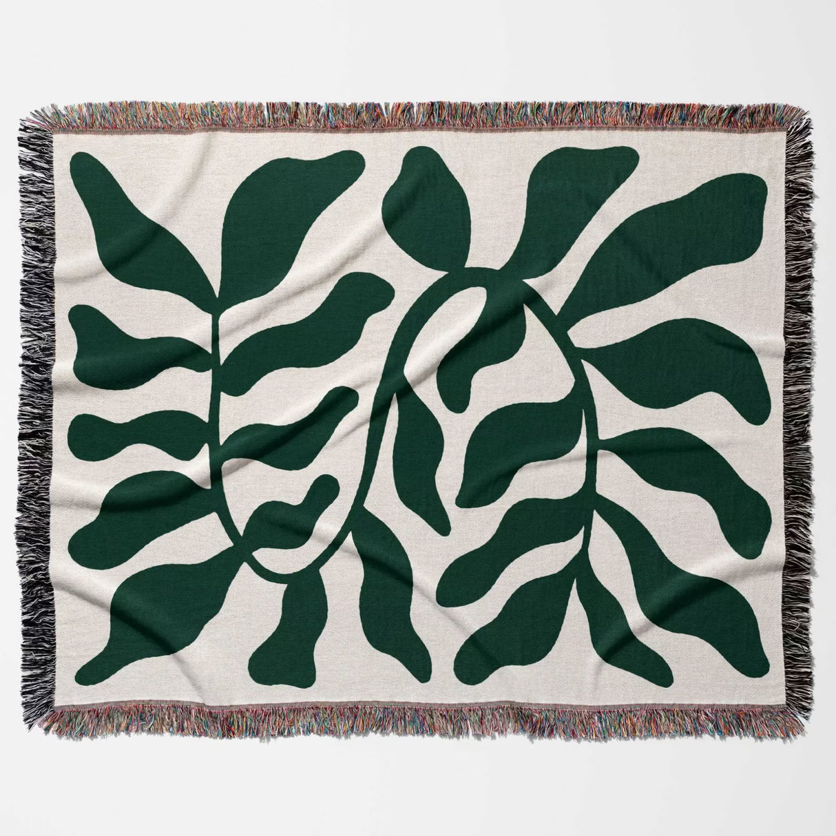 Forest green leaf Matisse throw blanket flat lay horizontally on a beige background