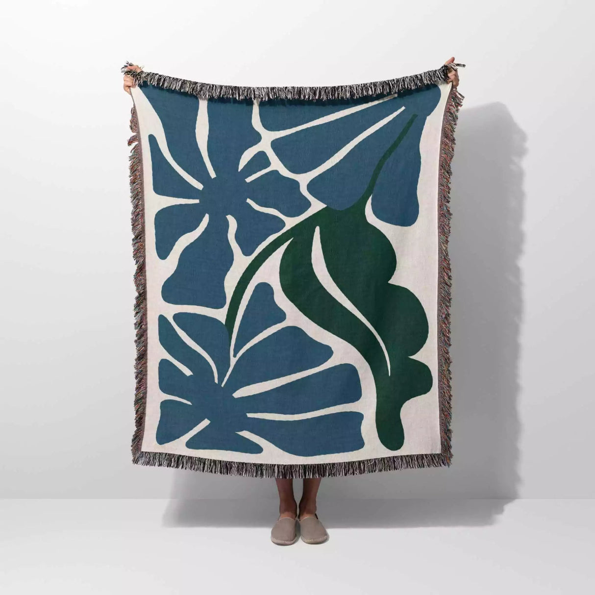 Henri Matisse blue flowers woven throw blanket with blue and green leaf pattern on a white background