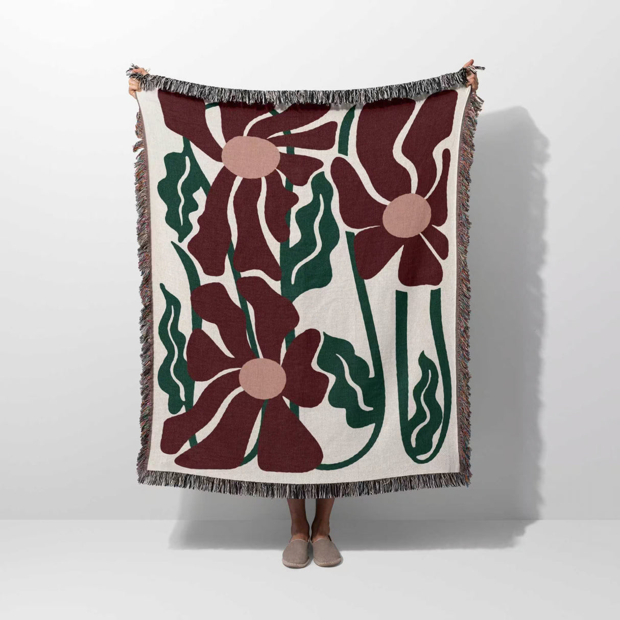 Floral patterned Matisse style blue pure cotton woven throw blanket with red flowers on a white background