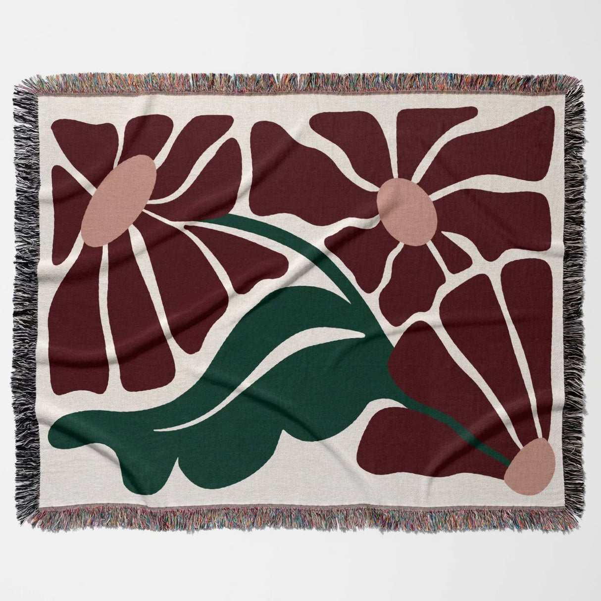 Floral patterned style botanical cotton woven throw blanket with red flowers and green leaves on a beige background