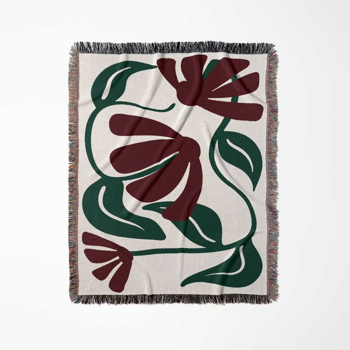 Floral patterned Matisse style red floral cotton woven throw blanket with green and red design on a white background