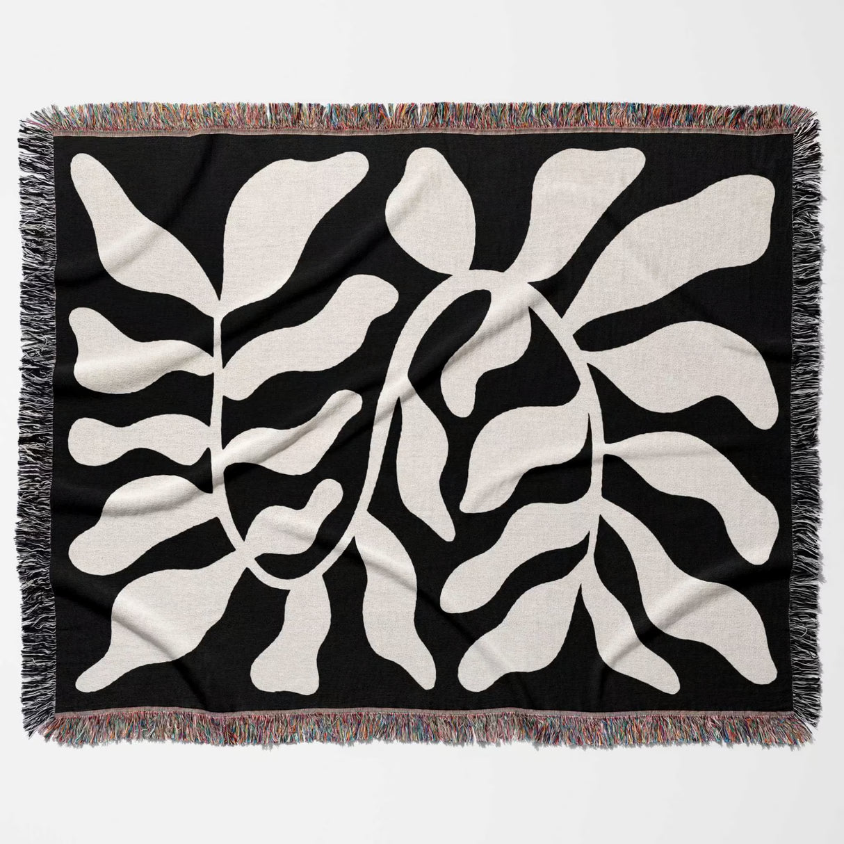 Black leaf Matisse throw blanket flat lay on a white background