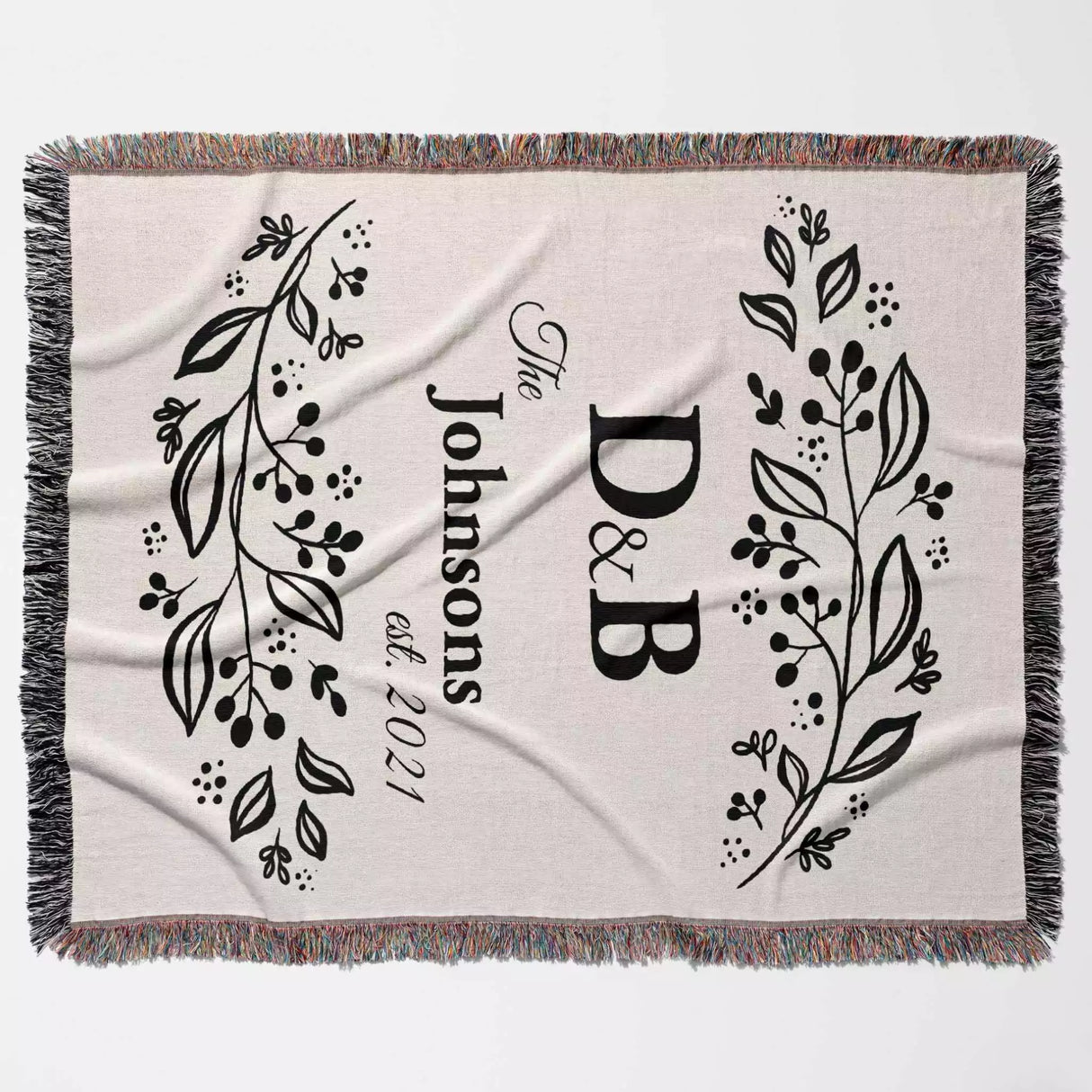 Monogrammed cotton throw blanket perfect engagement and wedding gift product full view on a light background