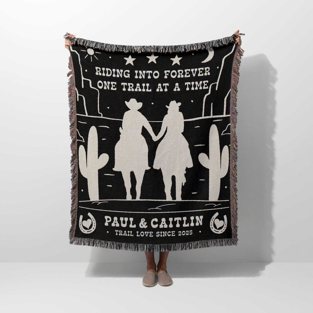 Personalized cowboy and cowgirl 2nd anniversary gift woven throw blanket with cowboy design and text held by a person on a white background