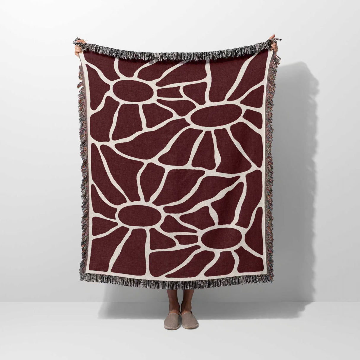 Red Matisse tapestry throw blanket for couch and chair hold by a person on a white background