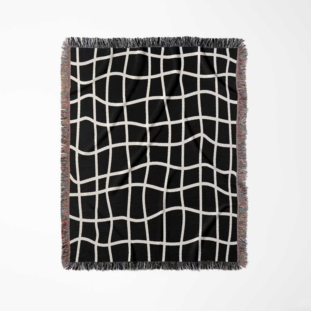 Black and white retro checkered woven blanket throw tapestry with fringe full view on a light gray background