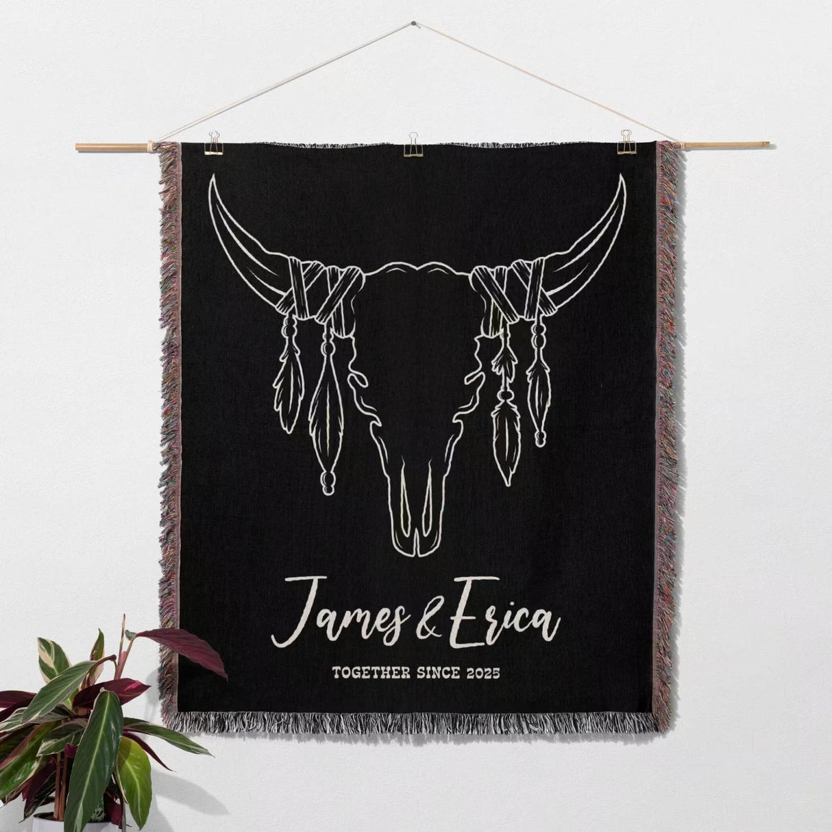 Rustic bull skull 2nd anniversary gift woven throw blanket with white bull skull design and text 'James & Erica Together Since 2023' on a white wall as a tapestry.
