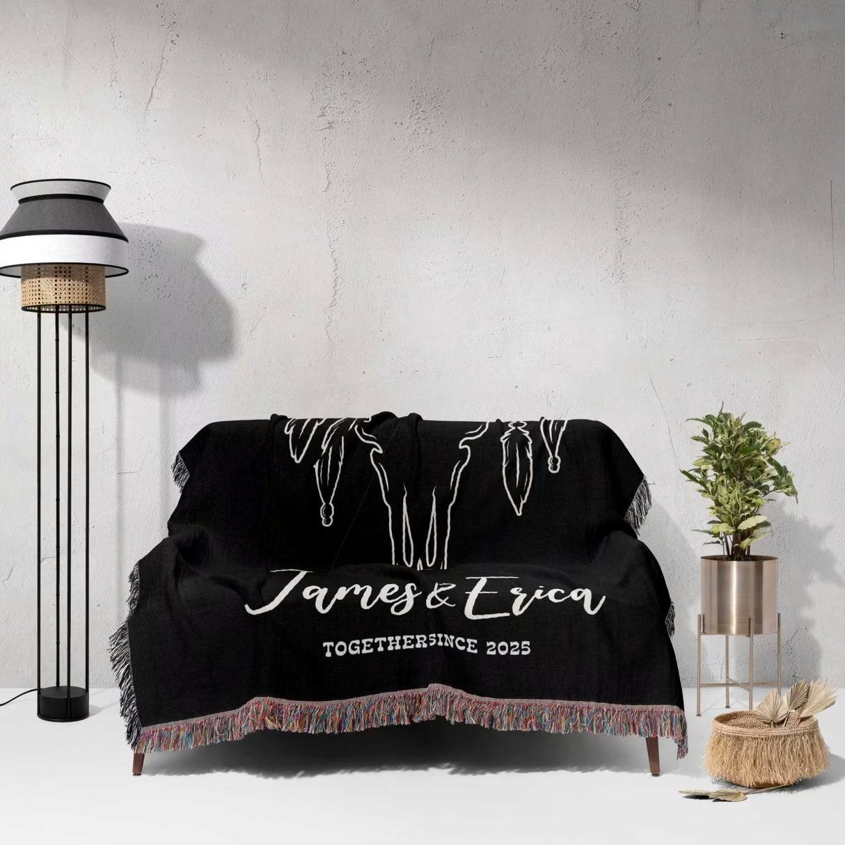 Rustic bull skull 2nd anniversary gift woven throw blanket with 'James & Erica Together Since 2025' text draped over a couch in a room.