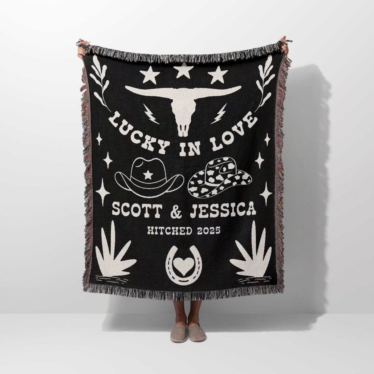 Rustic western 2nd anniversary gift woven throw blanket with white designs and text, featuring a longhorn skull and cowboy hats, on a white background.