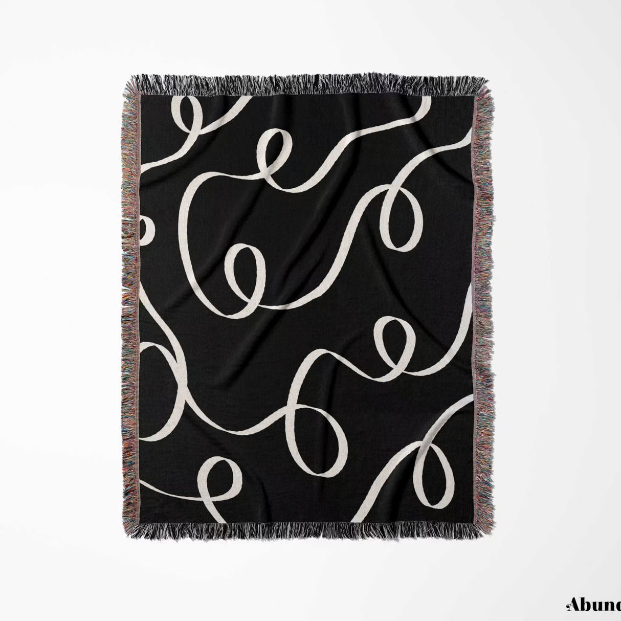 Black and white scribble lined woven blanket throw with fringe full view on a white background.