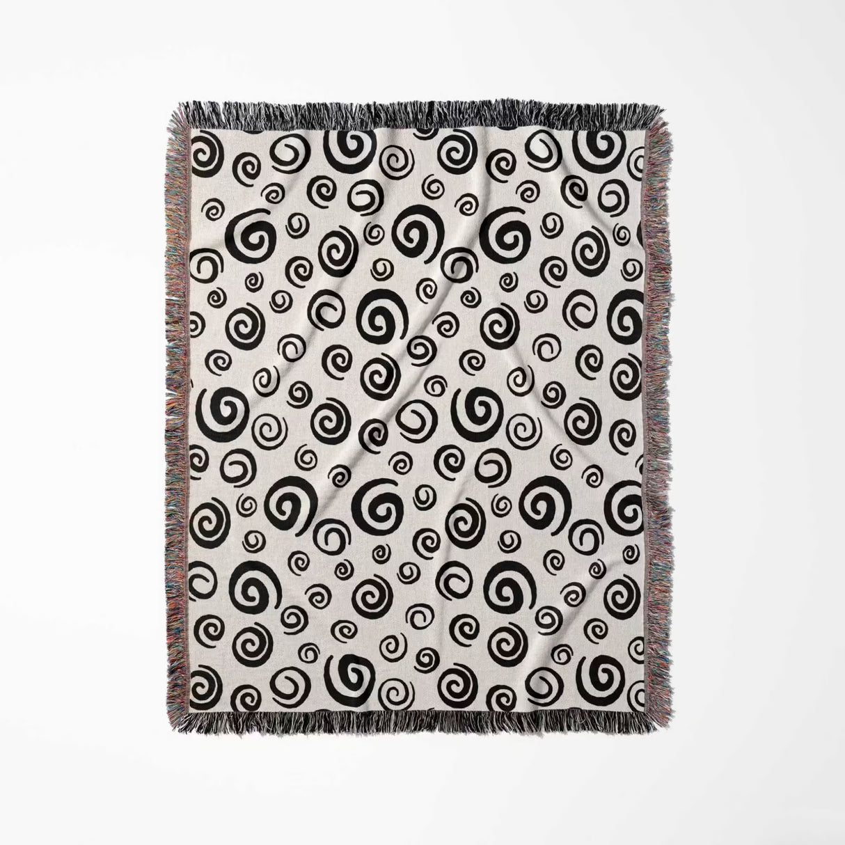 Black and white swirls patterned woven blanket throw with fringe vertical full view on a white background.