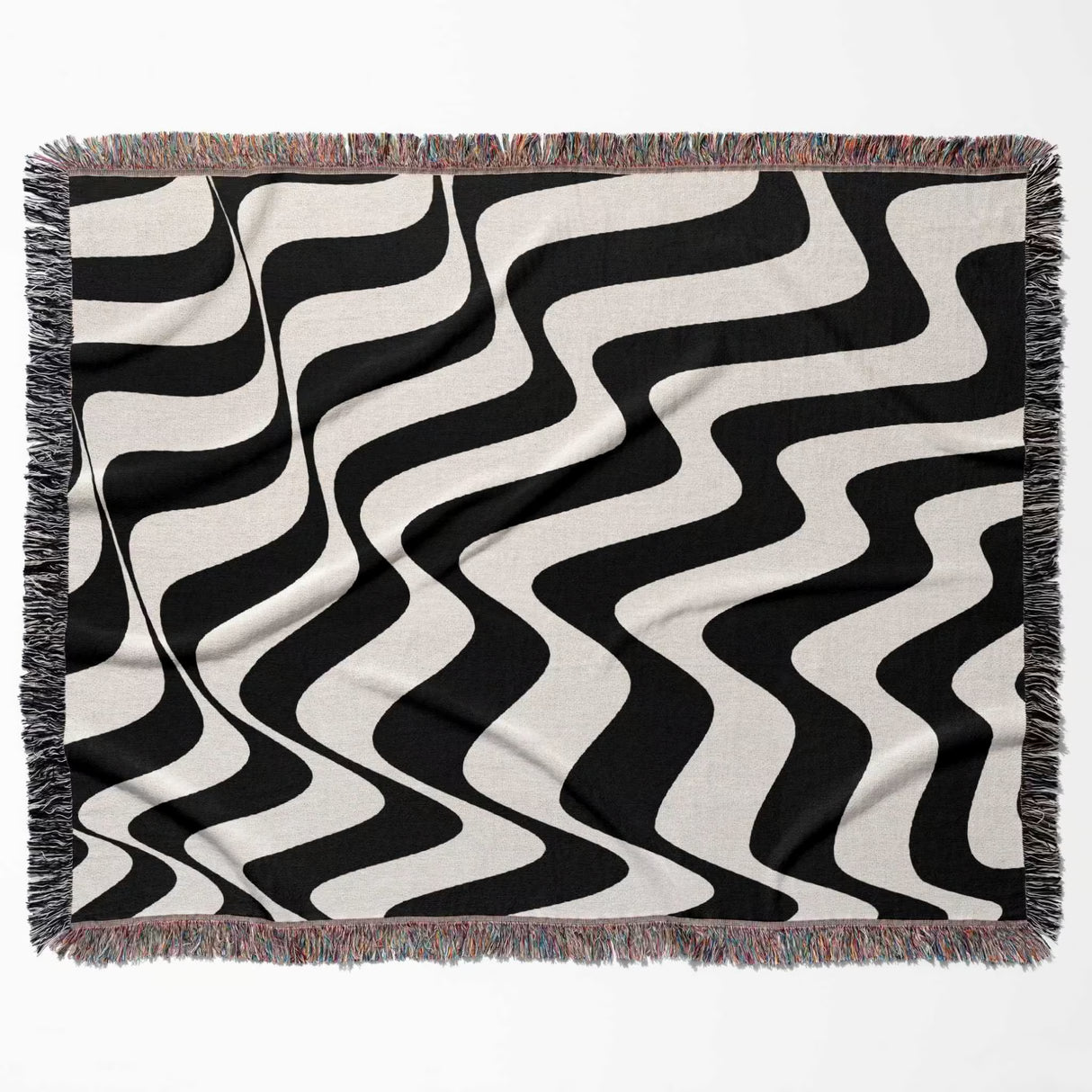 Black and white trendy abstract waves woven blanket throw tapestry horizontally flat lay on a plain background.