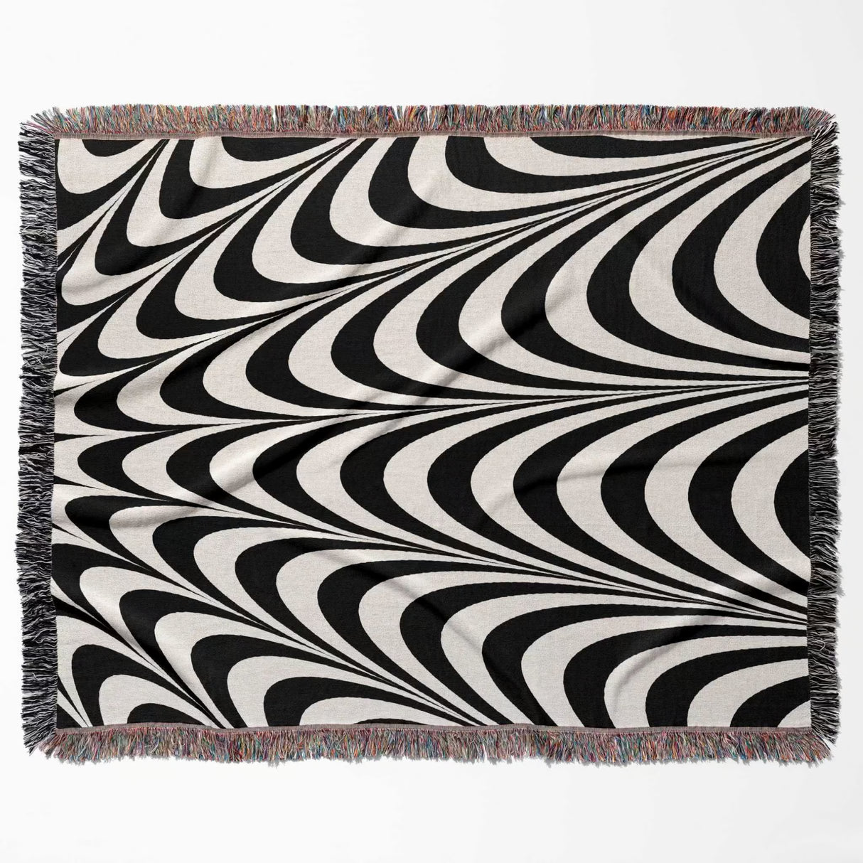 Black and white abstract art wavy woven blanket throw tapestry with fringed edges flat lay on a white background.