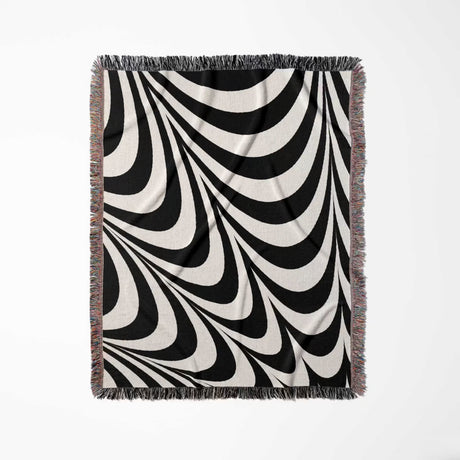 Black and white abstract modern artistic woven blanket throw tapestry with fringes full view on a white background.