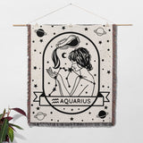 This image shows an Aquarius Zodiac Sign Blanket used as wall decor. The woven throw tapestry features an intricate black-and-white design of an Aquarius woman with celestial and constellation details. Perfect for adding an astrological touch to your home, it serves as both a decorative piece and a cozy blanket.