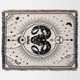 Displayed flat and horizontal, this Aries Zodiac Blanket features a striking ram design at its center, surrounded by celestial elements. The meticulous woven texture and multicolor fringe add to its charm, making it an ideal birthday gift for astrology enthusiasts.