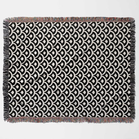 Black and white asian geometric pattern woven blanket throw tapestry flat lay on a white background