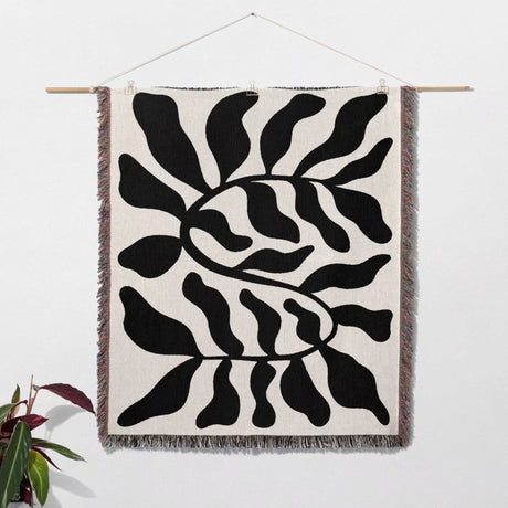 Black leaf Matisse throw blanket  as woven wall art with black abstract pattern on a white background