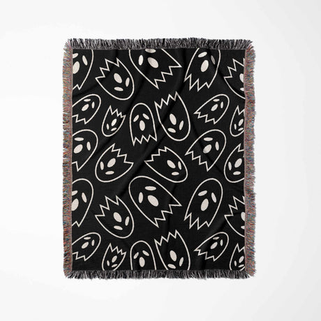 Black blanket with white ghost pattern on a white background
