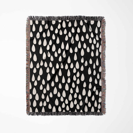 Black blanket with white teardrop pattern on a white background