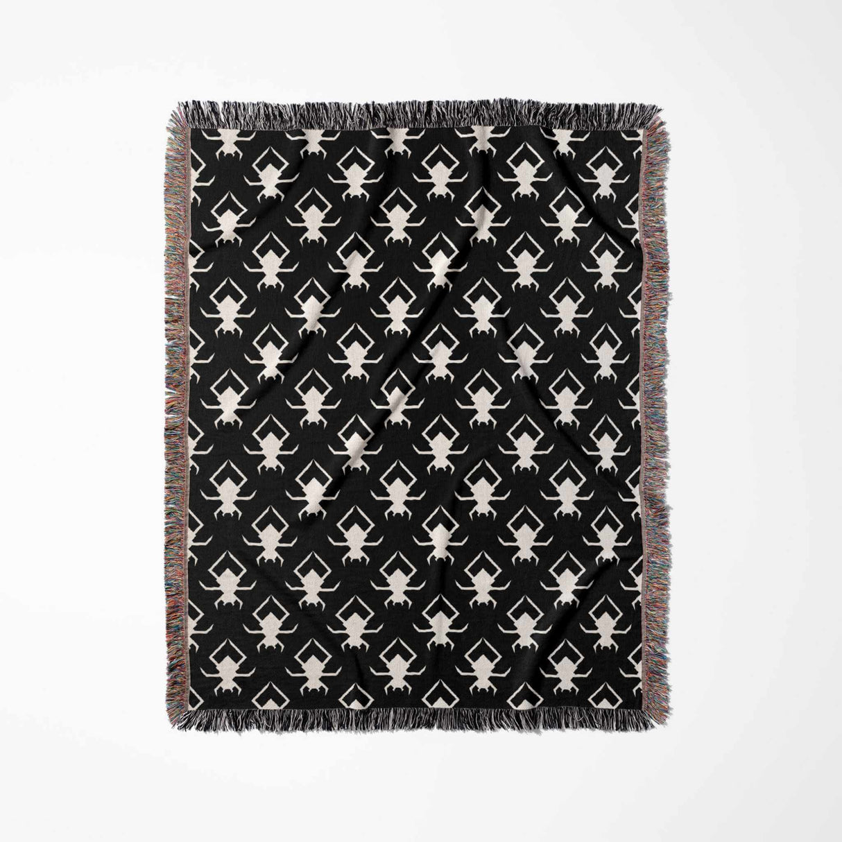 Black and white geometric spiders pattern woven throw blanket full view on a white background.