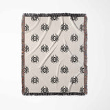 Blanket with black geometric pattern on beige background