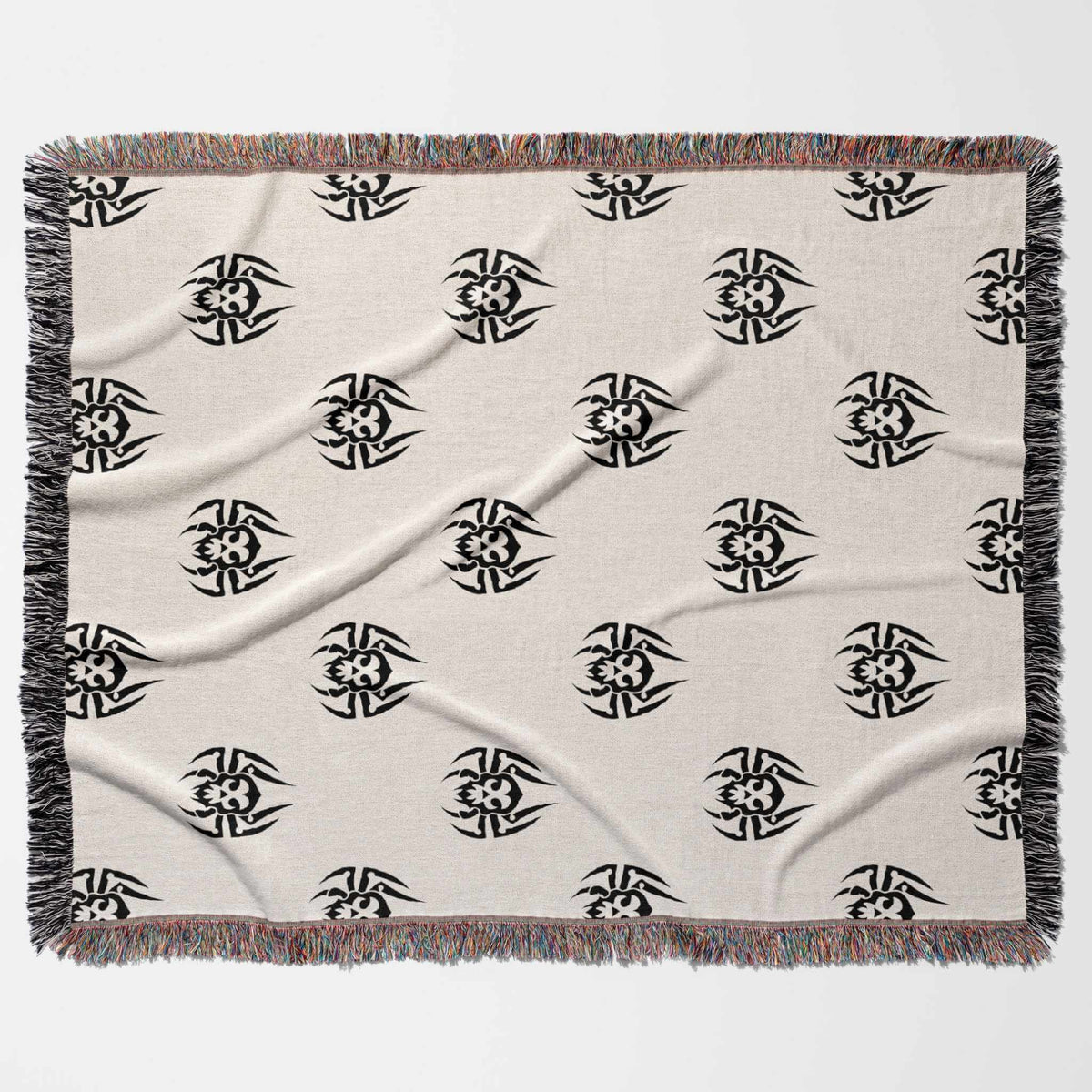 Beige blanket with black geometric patterns on a white background