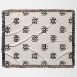 Beige blanket with black geometric patterns on a white background