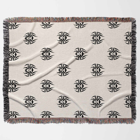 Beige blanket with black geometric patterns on a white background
