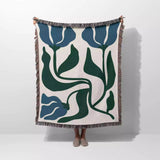 Floral patterned blanket blue and green Matisse flower woven throw blanket with blue and green design on a white background