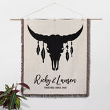 Bull skull boho wedding cotton anniversary gift – woven throw blanket with bull skull design and personalized text on a white wall.