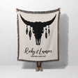 Bull skull boho wedding cotton anniversary gift – woven throw blanket with bull skull design and personalized text held by a person on a white background