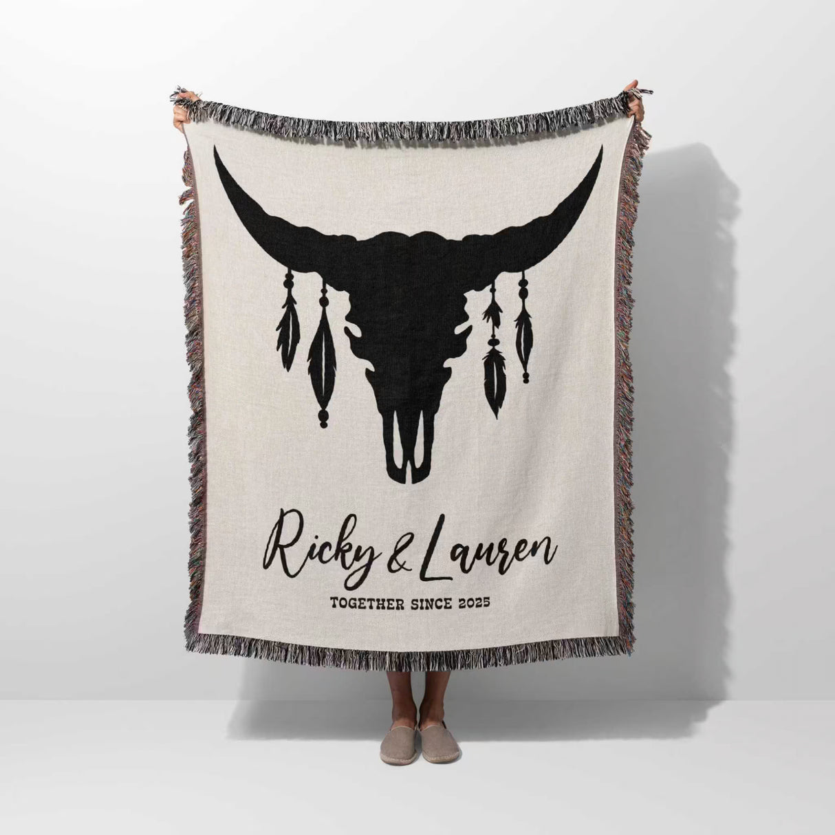 Bull skull boho wedding cotton anniversary gift – woven throw blanket with bull skull design and personalized text held by a person on a white background