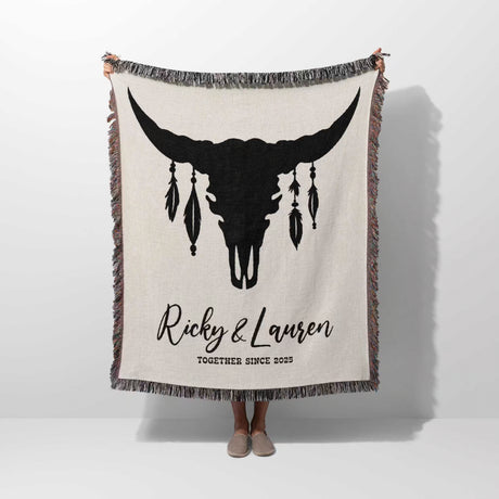 Bull skull boho wedding cotton anniversary gift – woven throw blanket with bull skull design and personalized text held by a person on a white background