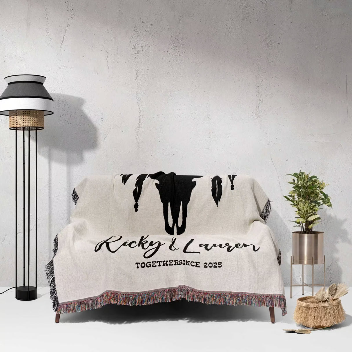 A sofa with a bull skull boho wedding cotton anniversary gift – woven throw blanket  featuring 'Ricky & Lauren TOGETHER SINCE 2023' text in a room setting.
